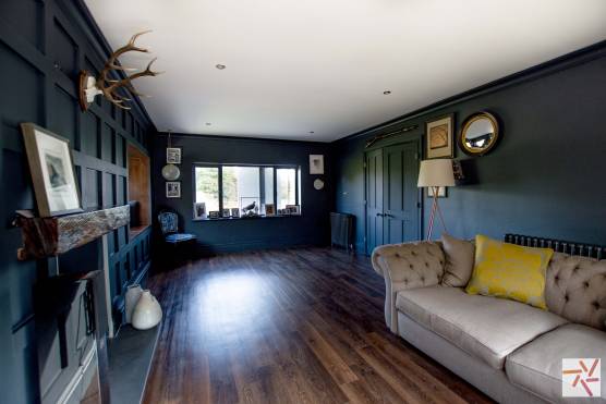 3251W 7 tv drama location house in west yorkshire blue living room with panelling.jpg