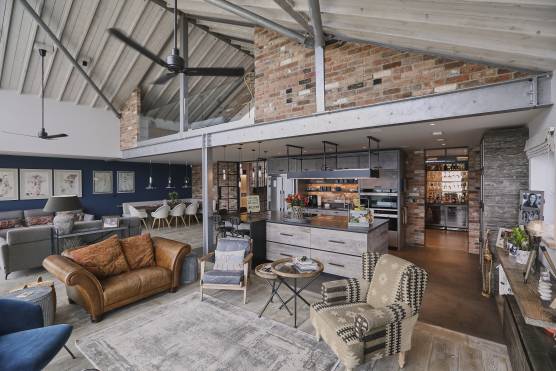 3275S 2 filming location house in Chichester open plan living with double height ceiling and exposed brick.jpg