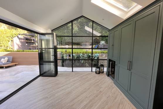 3436C 7 filming location house in Cheshire stylish open plan green kitchen with bi fold doors